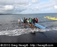 Crew launching a canoe