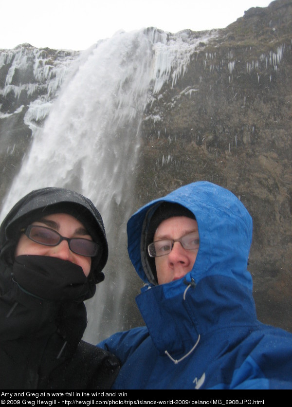 Amy and Greg at a waterfall in the wind and rain