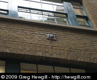 Guild shield on the side of a building