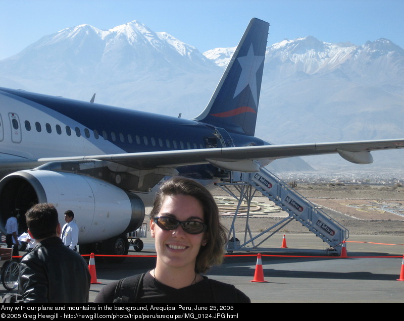 Amy with our plane and mountains in the background
