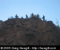 Workmen at the top of a hill