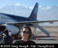 Amy with our plane and mountains in the background