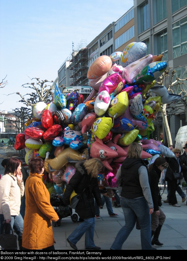 Balloon vendor with dozens of balloons