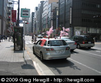 The car in the foreground was decorated with cherry blossoms
