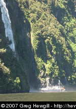 Boat nosing up to the waterfall