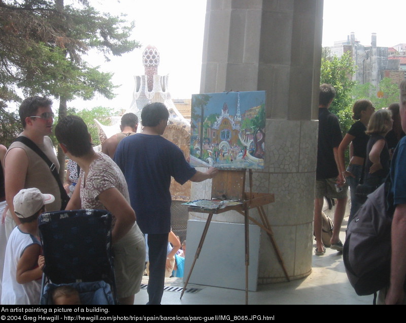 An artist painting a picture of a building.